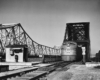 a passenger train crossing a large bridge