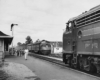 People waiting for a passenger train at a train station