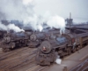 A handful of trains parked outside a rail yard