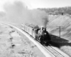 a steam engine pulling cars