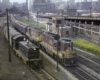 a couple of trains side by side with Chicago in the background