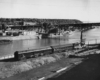 a diesel engine on a rail by a river with St. Paul in the background