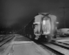 a passenger train covered in snow