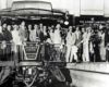 A group of people smiling outside a train