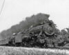 A train speeding by with black smoke coming out of its chimney