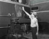 A worker cleaning the back of a train