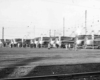 A distant shot of people boarding trains