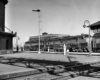 a diesel with passenger cars sitting in a station