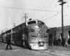 a diesel and passenger cars at a passenger depot