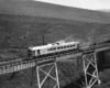 a passenger train going over a bridge