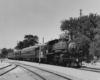 a steam engine pulling passenger cars