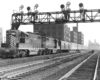 A train passing below a stoplight