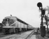 A train parked outside a stoplight