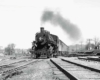 a steam engine pulling passenger cars