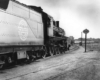 A black and white photo of two trains approaching each other