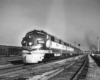 A black and white photo a an E7 locomotive on the tracks.