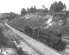 A black and white photo of locomotive 4-8-2 904 on the tracks turning a corner