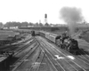 A black and white photo of locomotive 4-6-2 703 pulling into the rail yard