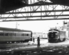 a diesel passenger train pulling into a train station