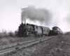 a diesel and steam engine passenger trains side by side