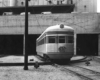 A black and white photo of a passenger car