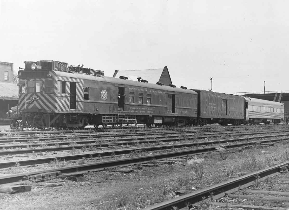 Motor car with two passenger cars in yard
