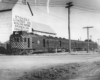 Motor car with two trailers by grain elevator