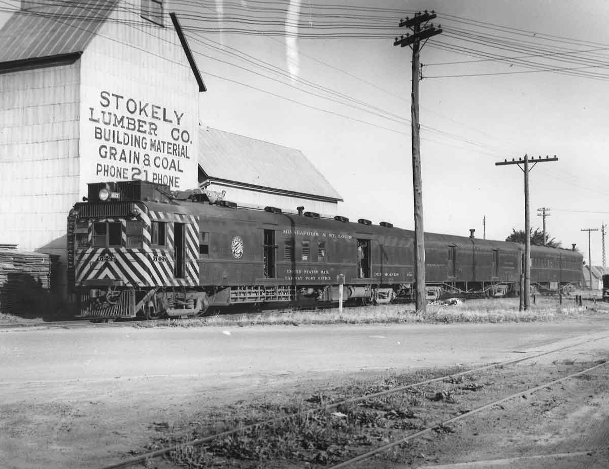 Motor car with two trailers by grain elevator