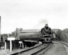 Steam locomotive with passenger train on curve on bridge