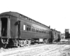 Rear of passenger train by wood water tower