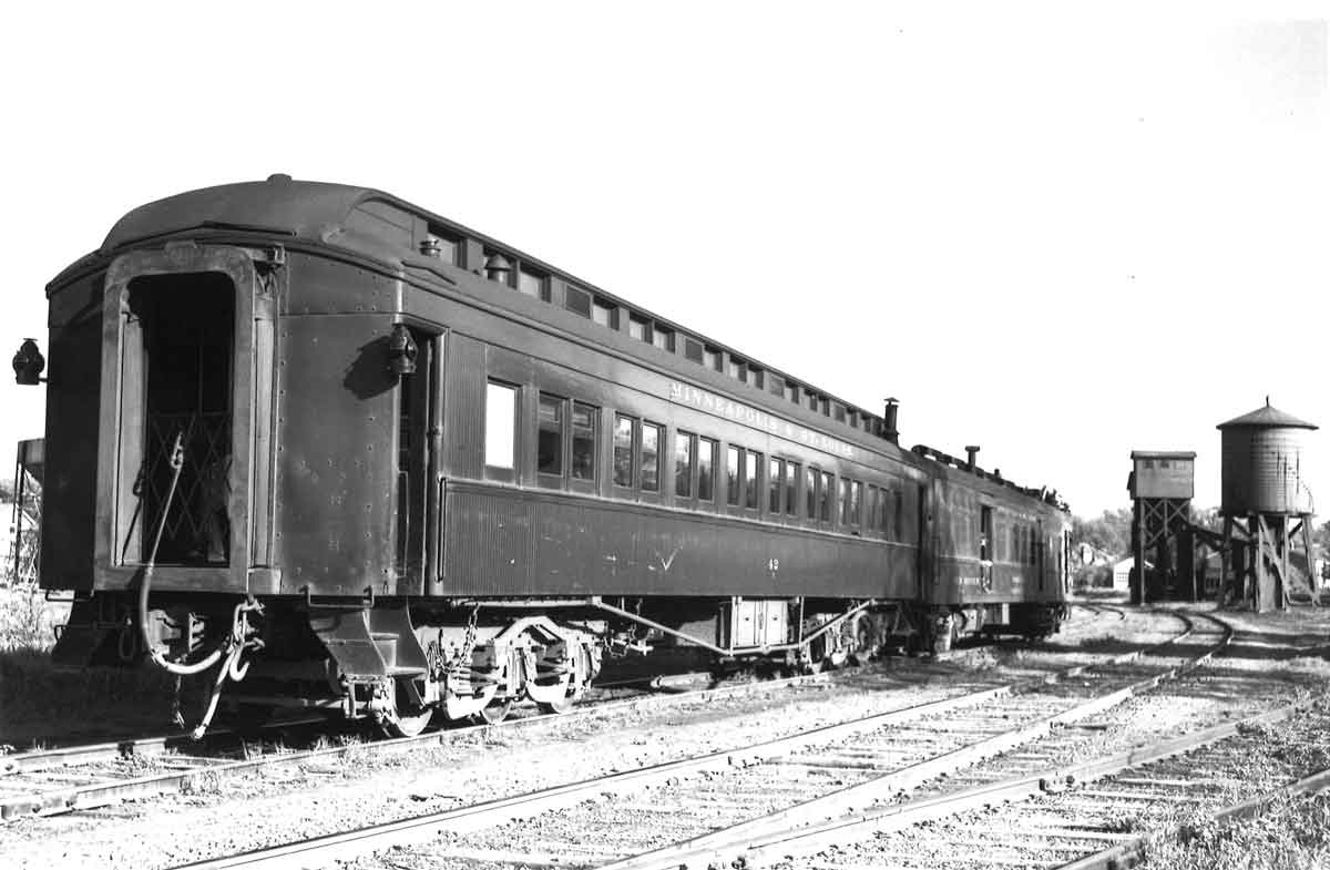 Rear of passenger train by wood water tower