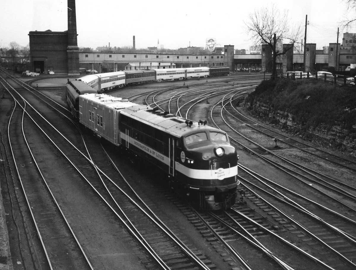 Diesel powered passenger train on curve by downtown station