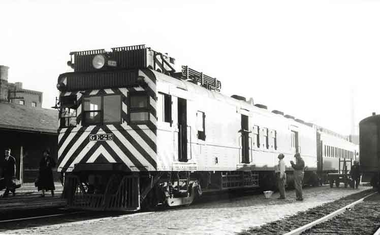 Motor car with coach at station