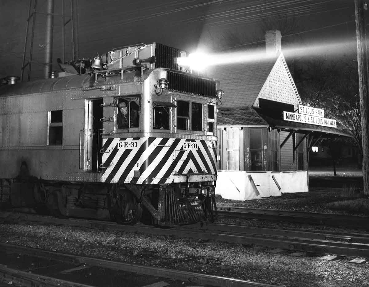 Motor car by station at night