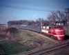 A red train approaching an intersection