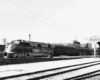 A black and white photo of a train passing a Wichita sign
