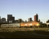 An orange and yellow train passing through Chicago