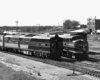A black and white photo of two trains side by side
