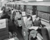 A black and white photo of passengers sitting in a train