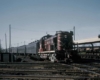 A red train approaching an intersection