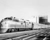 A black and white photo of a train passing by