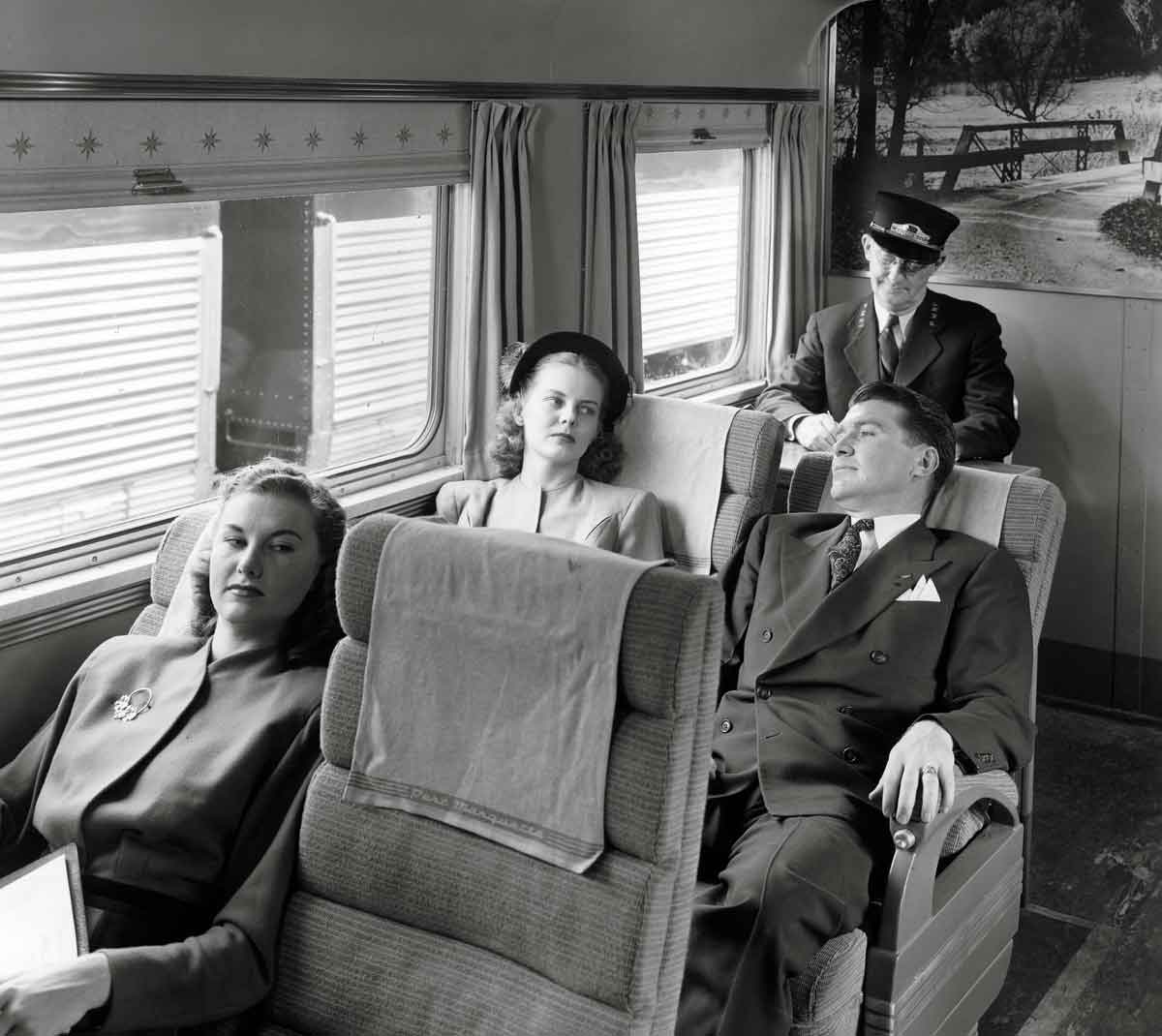 Three passengers relaxing on a train