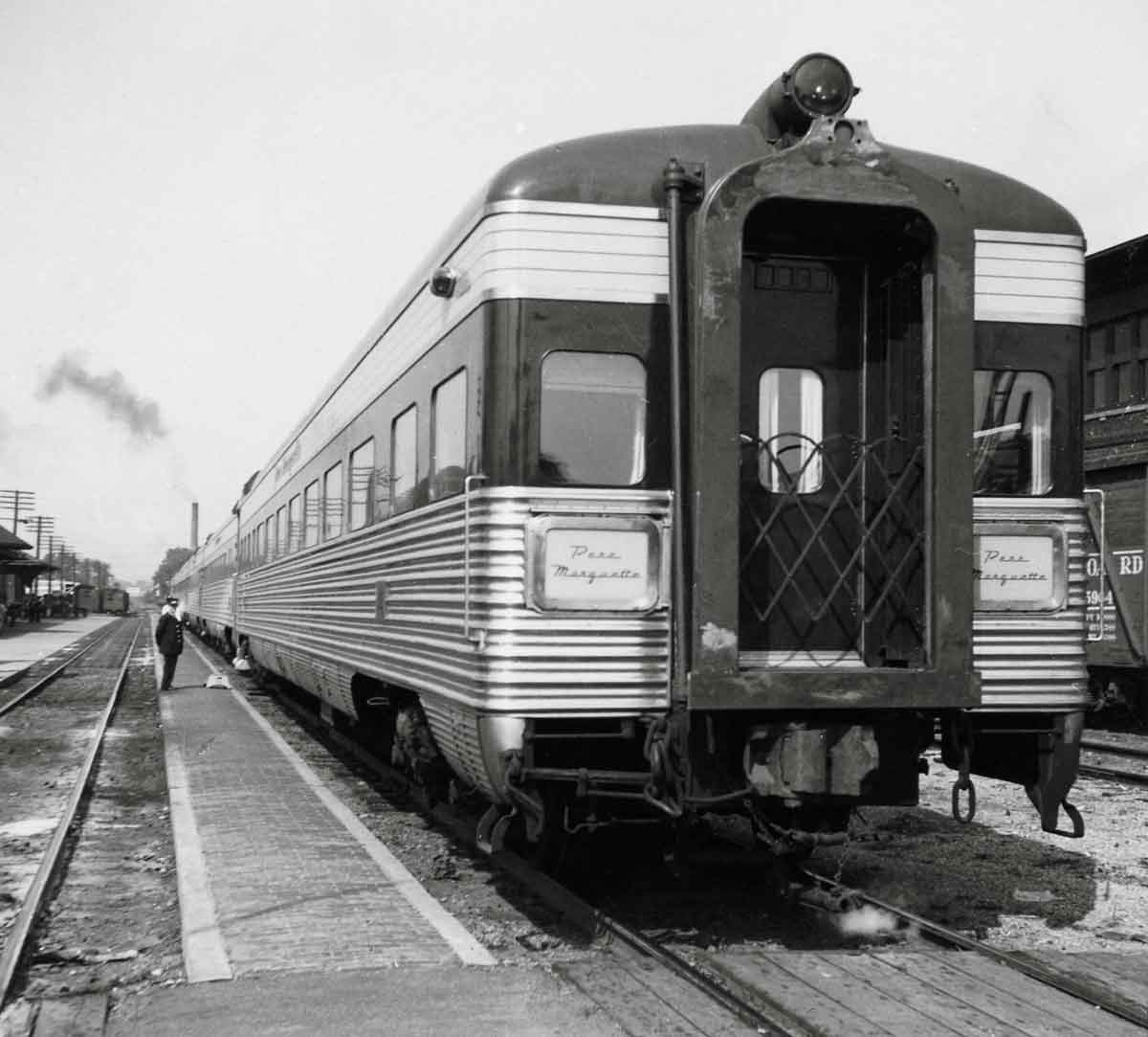 The back of a passenger car sitting on the tracks