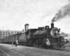 Four people standing outside a train