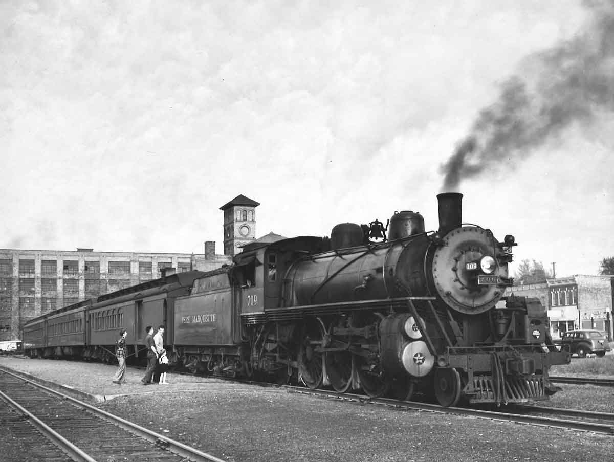Four people standing outside a train