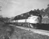 A black and white train moving down the track