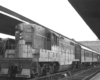 A black and white photo of a train parked at a station