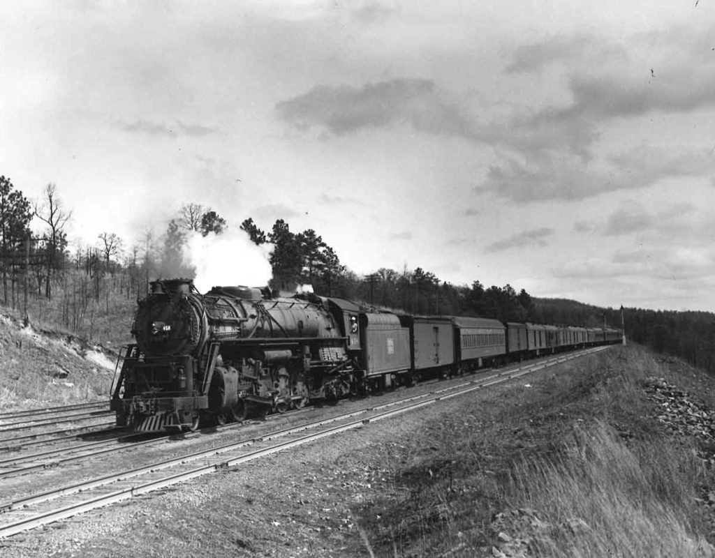 Steam locomotive on long passenger train