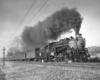 Smoking steam locomotive on passenger train