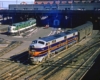 Diesel-powered passenger trains exiting elevated station